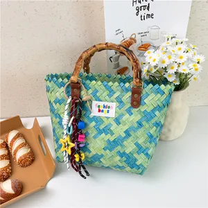 Blue and green gradient woven beach bag with bamboo handles and star charms
