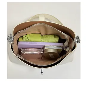 Spacious interior of off-white tote bag showing phone and umbrella storage capacity