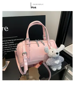 Pink mini cylinder handbag in glossy finish with cute teddy bear charm detail
