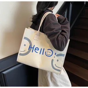 Detail of canvas tote bag with Hello print and smiling face for daily commuting