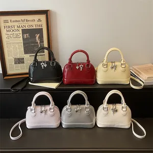 Fashionable semi-circular leather shell bags in six colors with heart charms