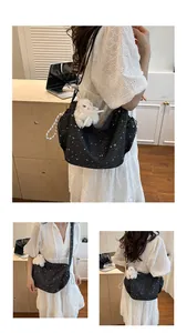 Detail of star print canvas tote bag featuring a cute white plush rabbit doll charm