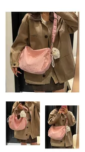 Macro view of pink star-patterned tote bag with a white plush bunny keychain accessory
