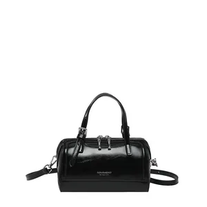 Glossy black retro cylinder shoulder bag with top handles and adjustable strap