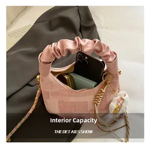 Detail showing internal capacity of the pink dumpling bag with cute plush bunny charm