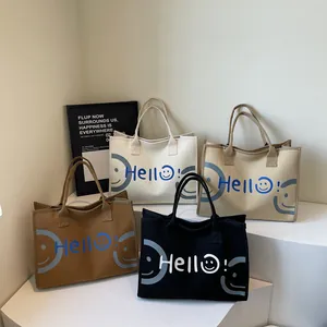 Minimalist canvas tote bags with 'Hello!' smile design in black, beige, and brown colors