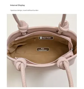 Internal view of the pink faux leather handbag showing main compartment and zipper pocket