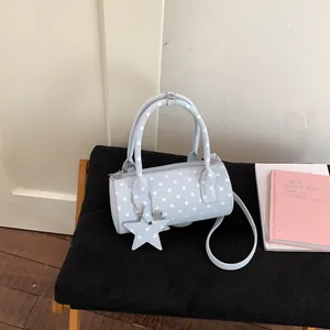 Light blue polka dot cylinder handbag with star charm and long shoulder strap