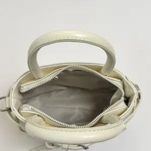 Chic cream bow handbag with wrinkled leather texture and silver hardware details