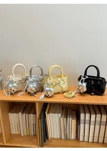 Mini handbags in various colors featuring cute plush bear charms and adjustable straps