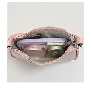 Internal view showing storage capacity with compartments in this pink shoulder bag