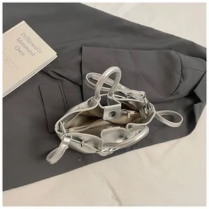 Top view of silver metallic bucket bag showing spacious interior with zipper pocket