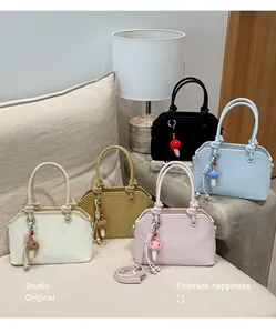 Close-up of minimalist faux leather handbags in five colors with Muting logo and mushroom charms