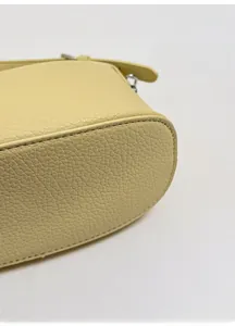 Detailed close-up of the reinforced bag bottom with premium litchi grain texture