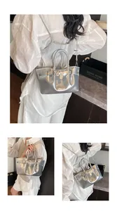 Detailed view of shiny silver metallic bucket bag with decorative buckle and dual handles