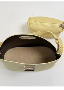 Top view of yellow lychee leather handbag with silver lock and matching mini zipper pouch