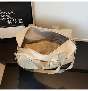Top view of open beige travel bag showing spacious interior compartments and zip pockets