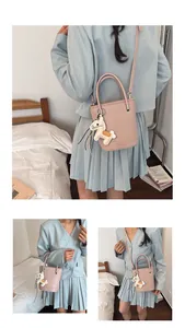 Pink bucket bag with horse charm detail, showing versatile shoulder and crossbody straps
