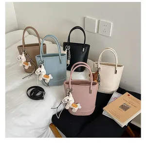Detailed collection of textured leather bucket bags in five colors with charms