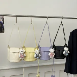 Minimalist bucket style crossbody bags in four colors with cute white bear charms