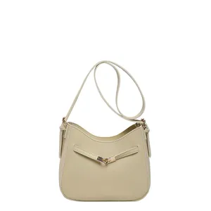 Minimalist beige PU leather hobo bucket bag with cross straps and adjustable shoulder strap