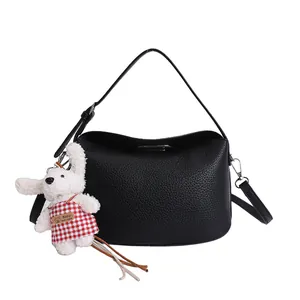 Chic black litchi pattern half-moon handbag with a cute plush bunny charm