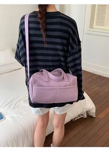 Close-up of lavender purple lychee grain leather boston bag with slim shoulder strap