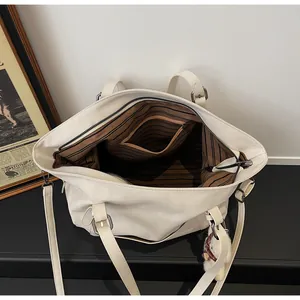 Macro view of white tote interior with striped lining and large storage capacity