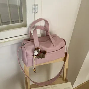 Detailed texture of pink pebble leather bag with a cute plush horse charm on a chair