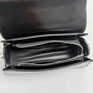 Chic black glossy handbag with internal zip compartment and silver hardware view