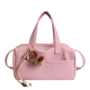 Pink lychee grain leather Boston bag with a cute horse charm and versatile crossbody strap