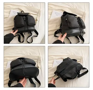 Detail view of the black multi-pocket oxford backpack with durable faux leather base