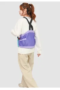Close-up of purple breathable mesh running vest showing adjustable X-shaped straps