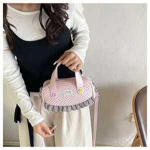 Pink polka dot square crossbody bag with floral accents and black-white checkered ruffles