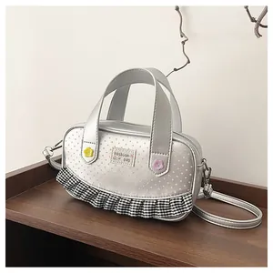 Detail of silver crossbody bag featuring pink dots and Fashion Bag floral embroidery