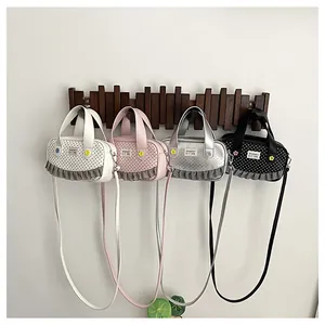 Detail of square crossbody bags with polka dots and ruffled edges in four colors