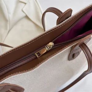 Large casual canvas tote bag in beige and brown with golden zipper and purple lining