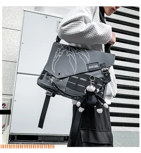 Detail of waterproof nylon messenger bag with techwear chain and monkey charm detail
