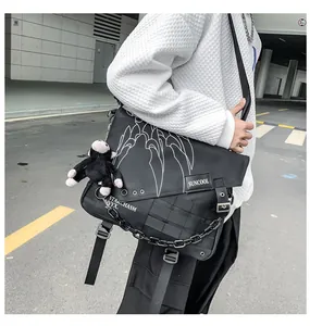 Detail of waterproof nylon crossbody bag featuring white claw patterns and monkey charm