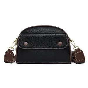 Classic black leather shell bag with brown canvas strap and gold metal hardware for women