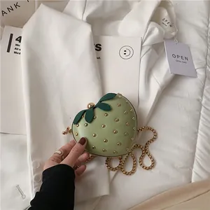 Chic strawberry-shaped chain bag in light green PU leather with gold rivet accents