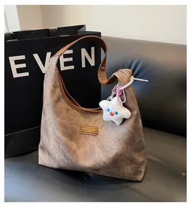 Close-up of vintage brown tote bag texture with fashion label and star plush charm
