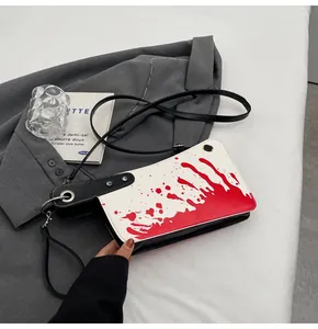 Artistic blood splatter crossbody bag with silver rivets and black adjustable strap