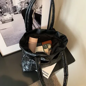 Large black quilted tote bag showing spacious interior with everyday essentials inside