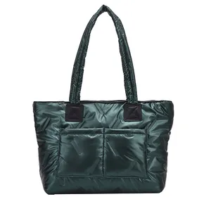 Deep green quilted tote bag with large pockets and a stylish metallic finish nylon