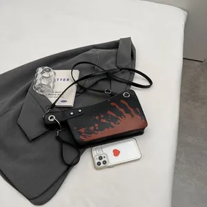Creative meat cleaver crossbody bag with black faux leather and red splatter design