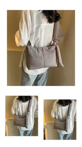 Detail view of a grey quilted puffer shoulder bag featuring a unique knotted strap design