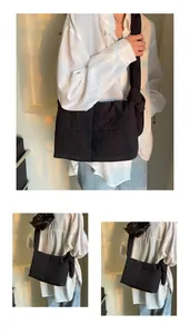 Close-up of quilted black crossbody bag featuring knotted strap and puffy nylon texture