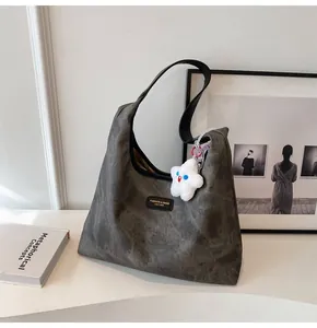 Close-up of grey vintage tote bag texture with fashion label and star plush charm