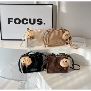Detailed group view of minimalist drawstring bucket bags in various retro colors with charms
